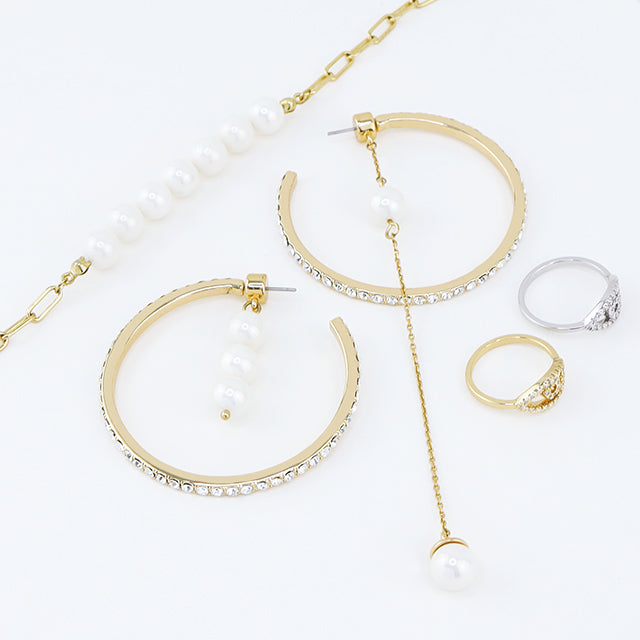 Pearl chain bracelet, asymmetric pearl hoop earrings and two colors evil eye rings. Click the picture to shop the Guardian Angel collection.