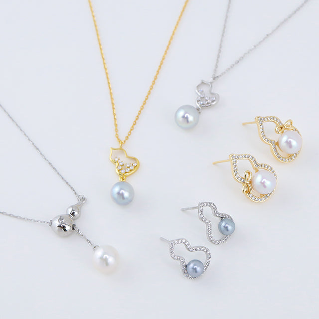 Different types groud pendants with pearl drop. A pair of grey pearl silver earrings and white pearl gold earrings. Click the picture and get more detail about Wulu Series jewelry.