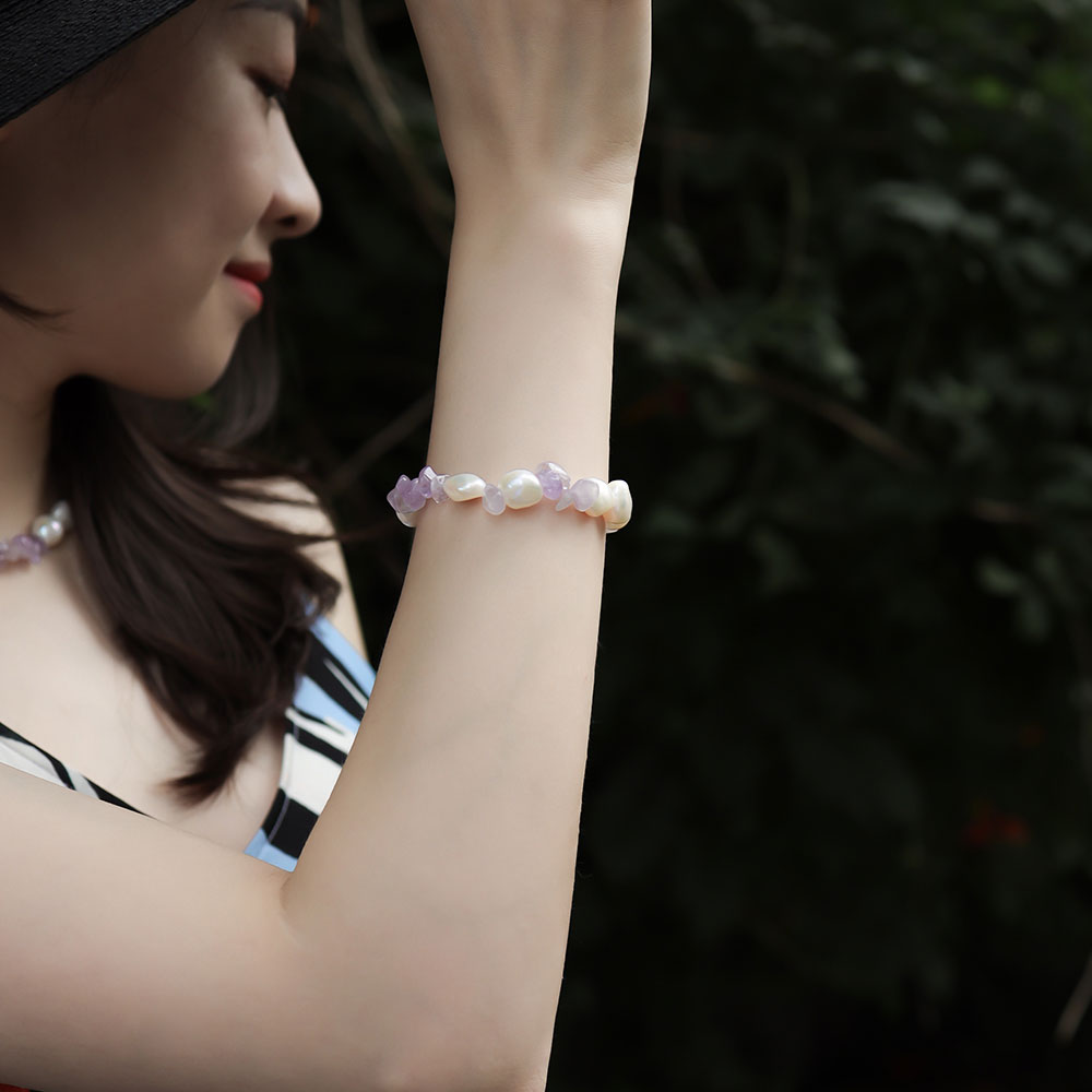 Women wear a amethyst and pearl bracelet.