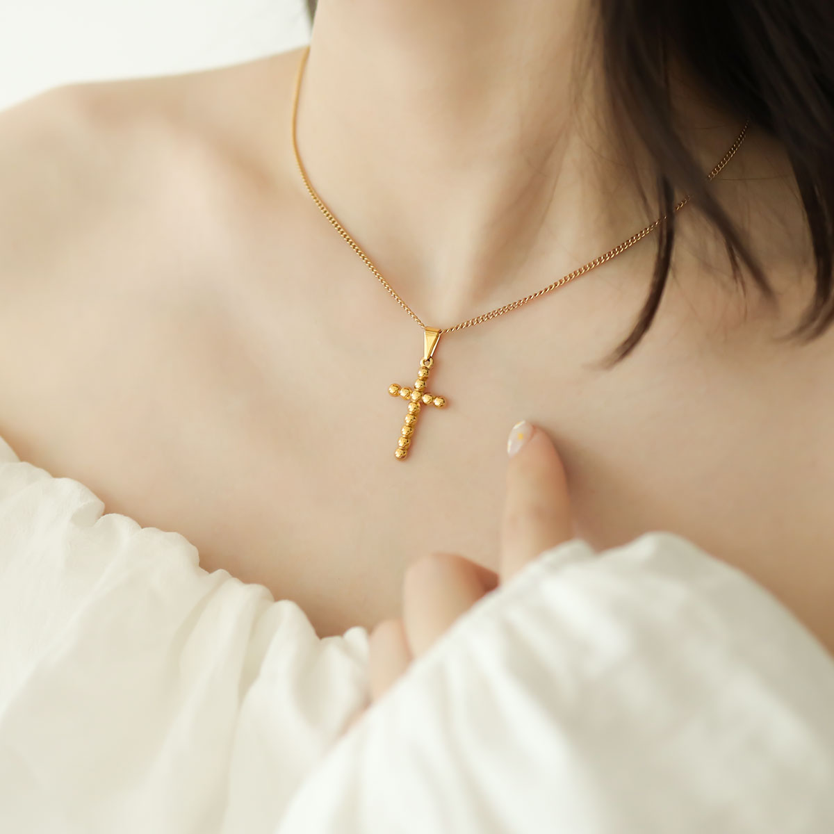 Women wear cross charm necklace.