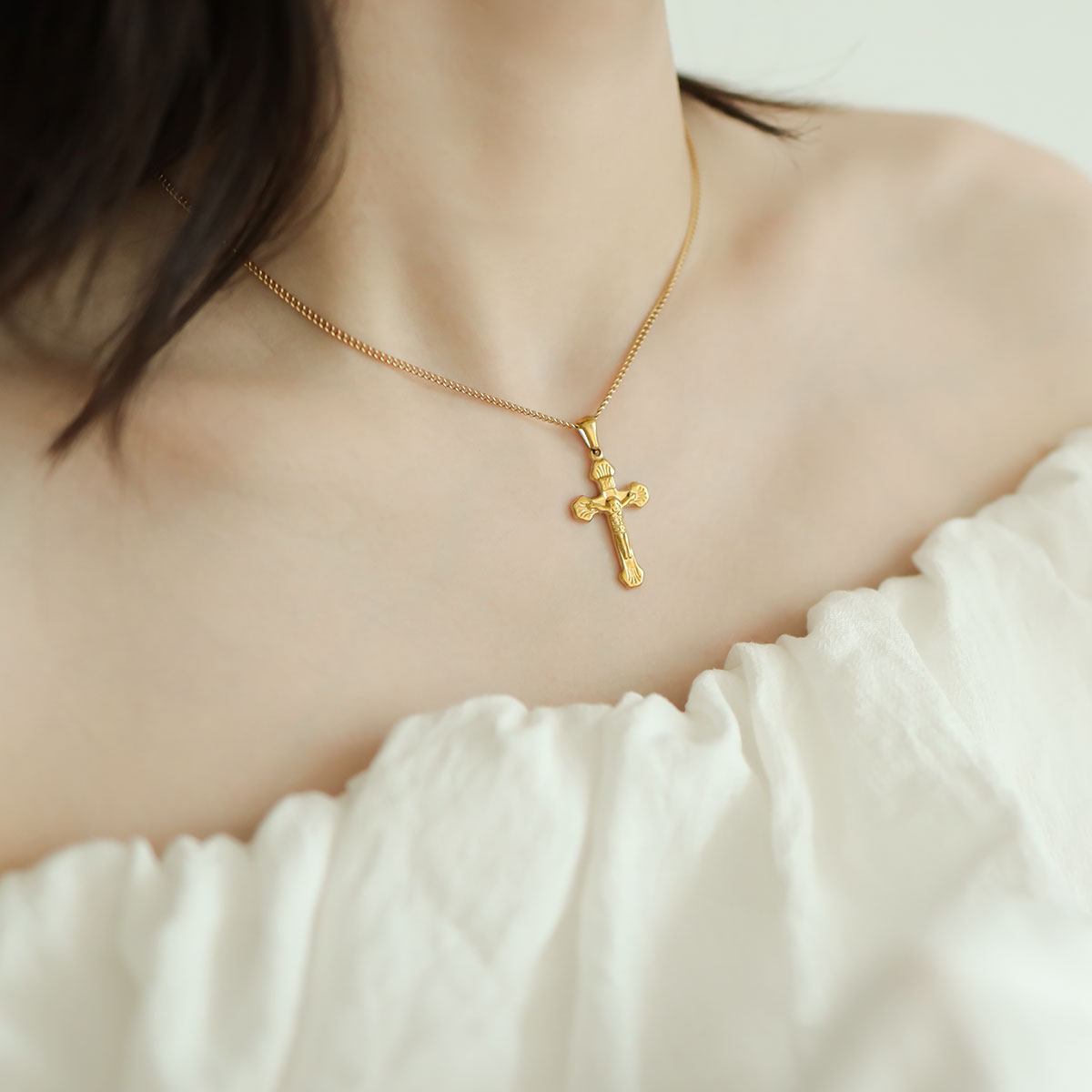 Women wear a cross pendant.