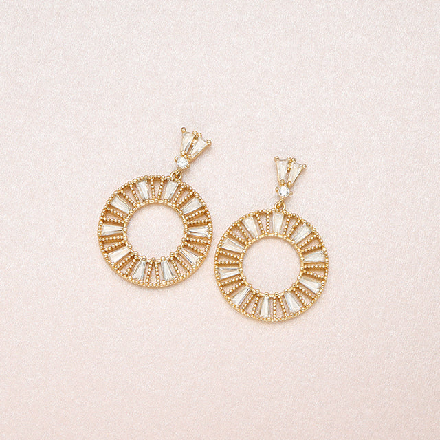 A pair of dangle hoop earrings in white.