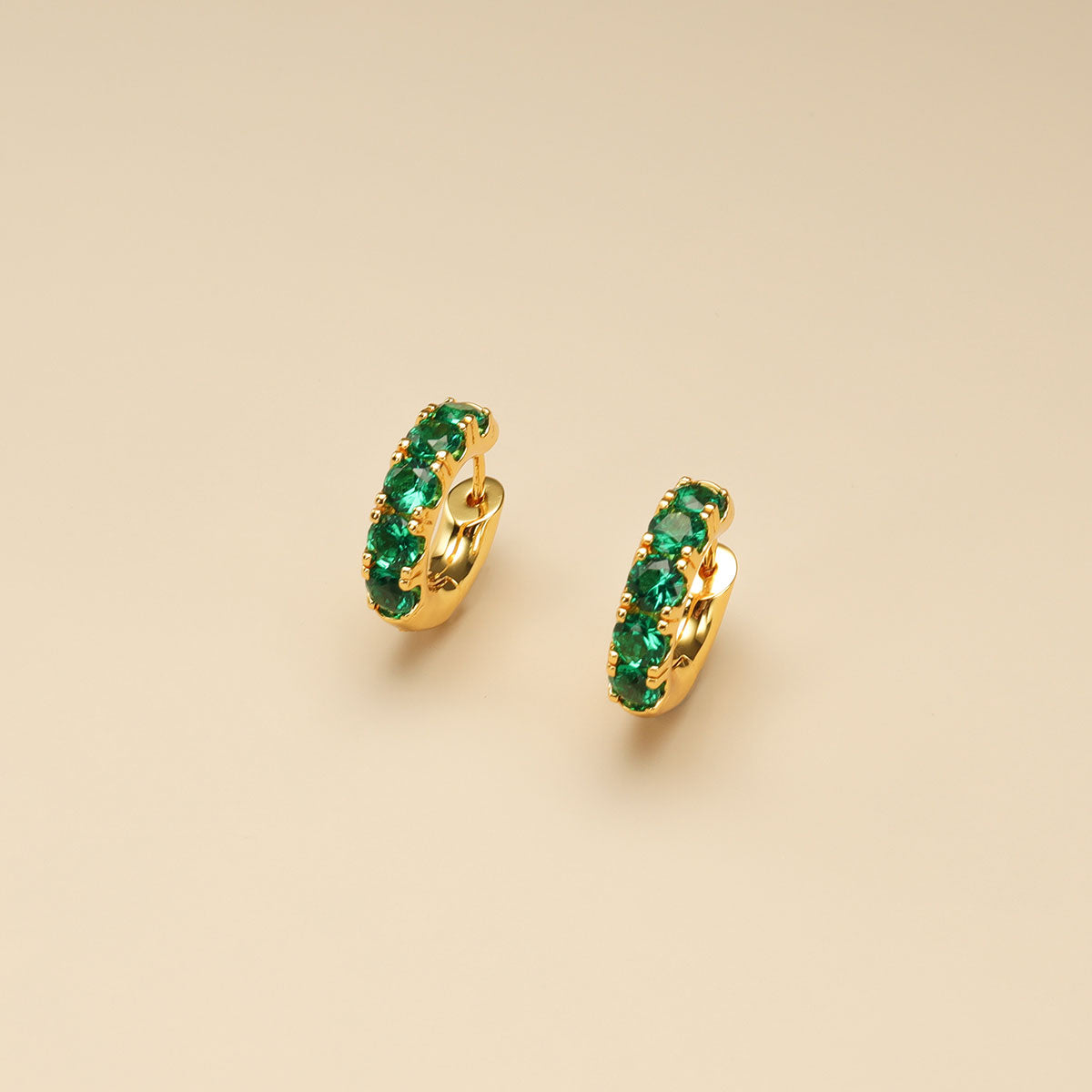  A pair of emerald green earrings.