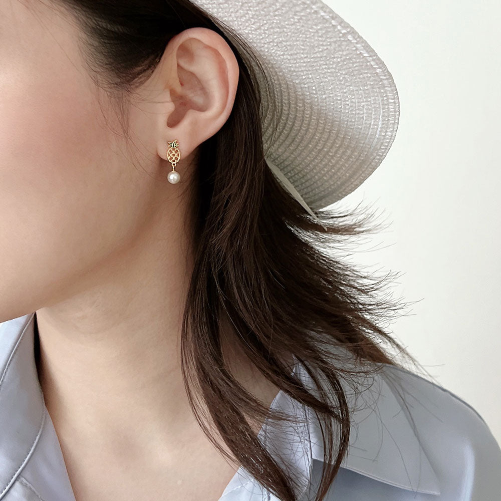 Women wear fruit earrings.