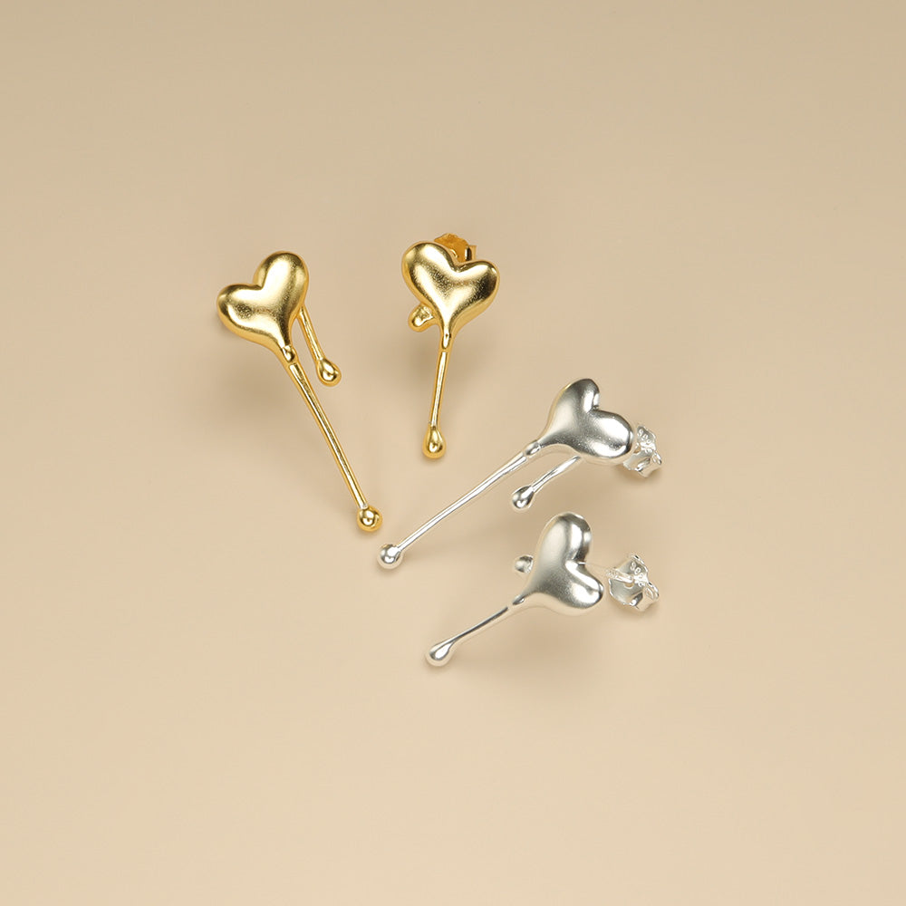 Gold and silver heart studs.
