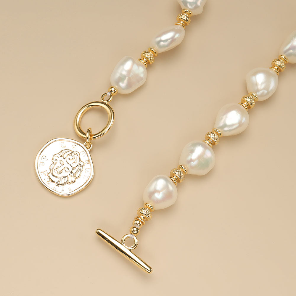 The gold toggle clasp on gold coin pendant.