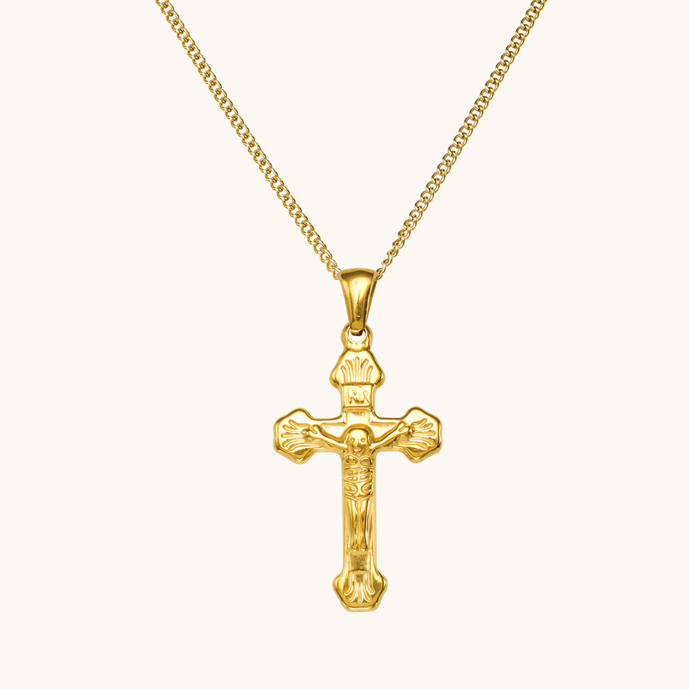 A gold cross pendant.