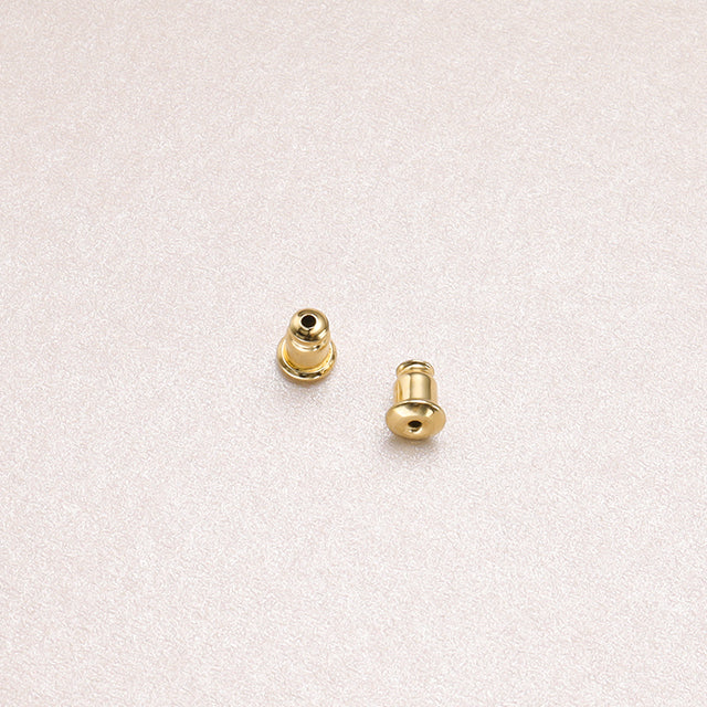 A pair of gold earring backs.