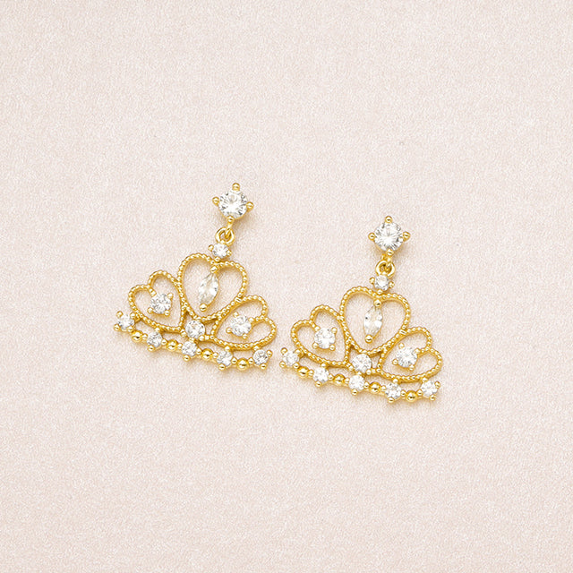 A pair of gold elegant earrings.