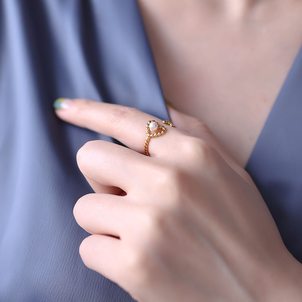 Women wear gold heart ring.