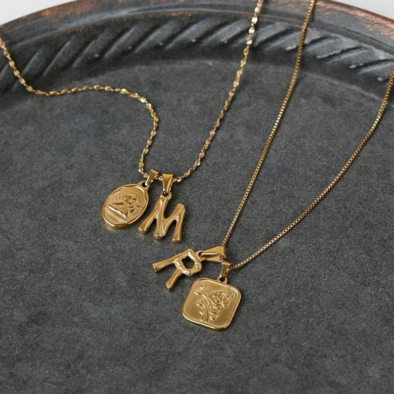 Gold initial charms with rose and angel charms.
