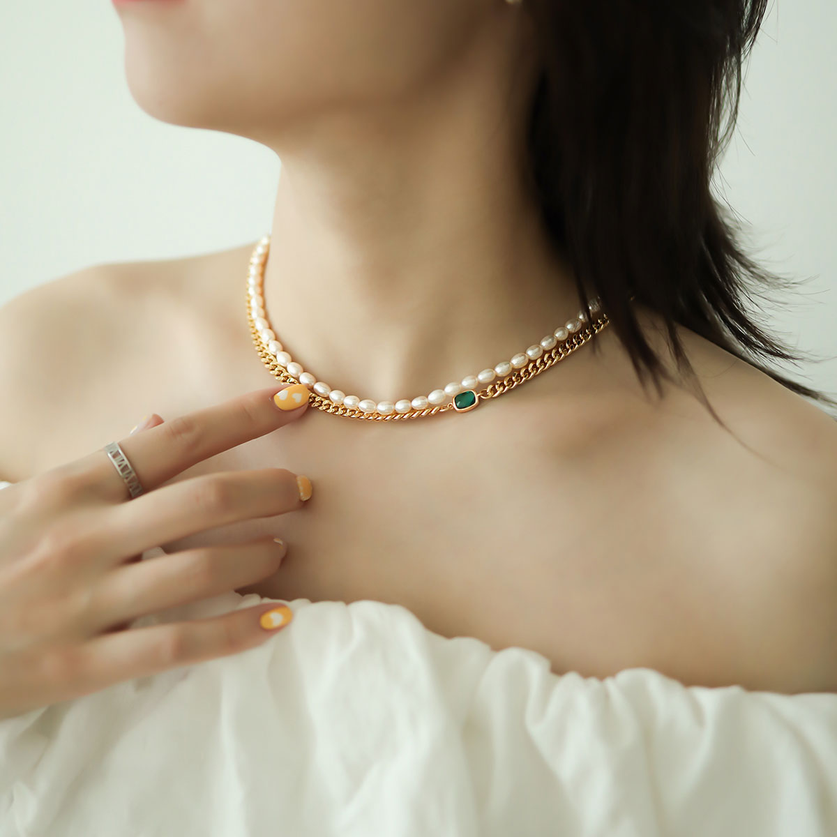 Women wear a gold layeres necklace set.