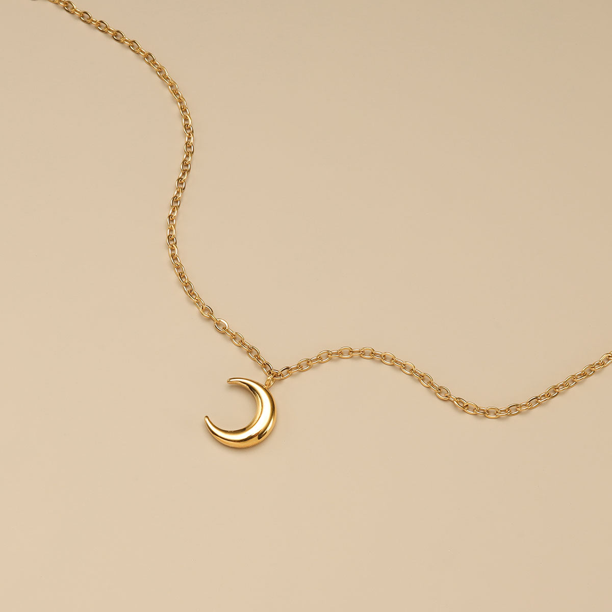 A close shot of gold moon bracelet.