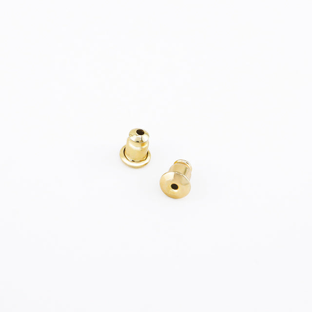 A pair of gold plated earrings backs.