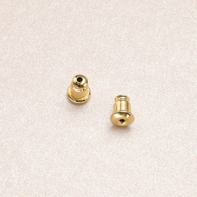 A pair of gold studs earring backs.