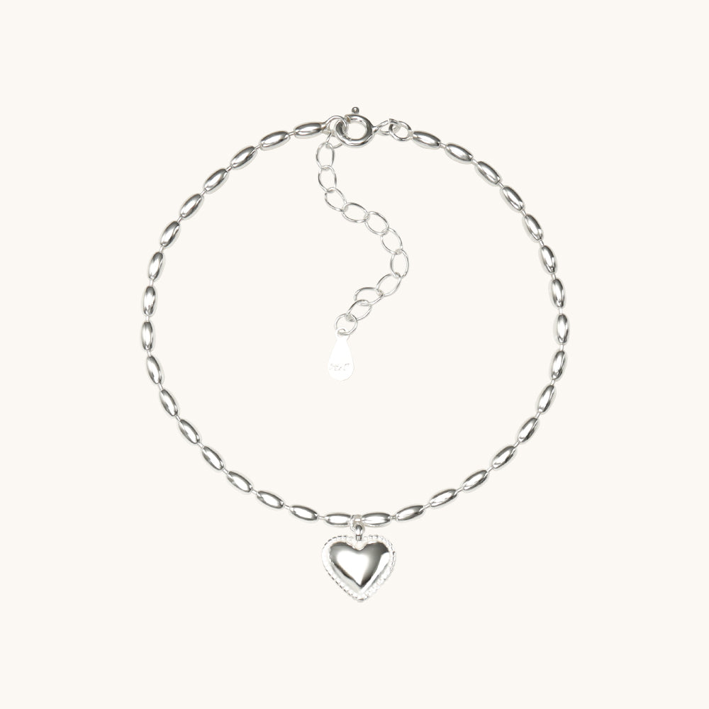 A silver heart bracelet.