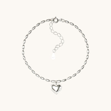 A silver heart bracelet.