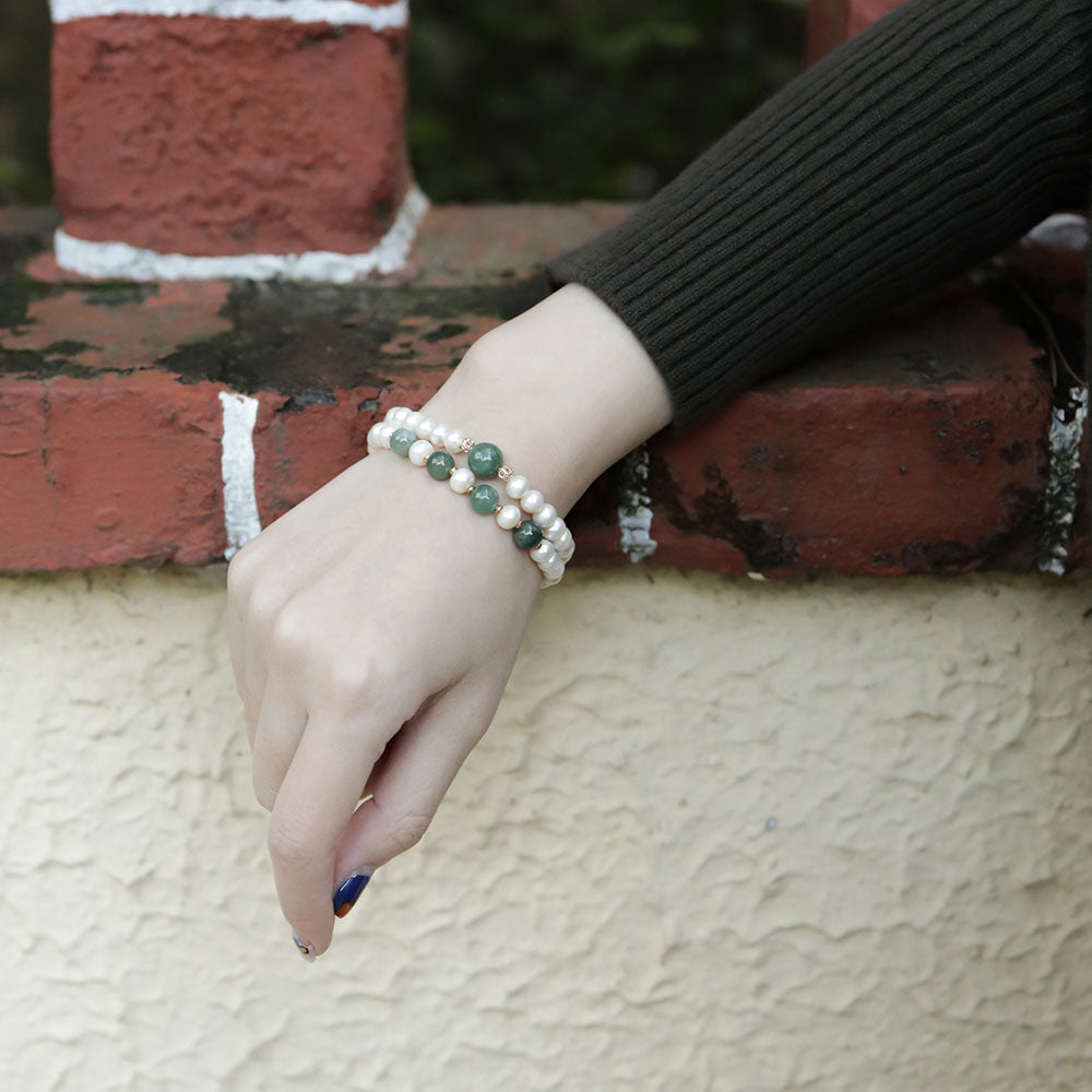 Women wear two jade bracelets.