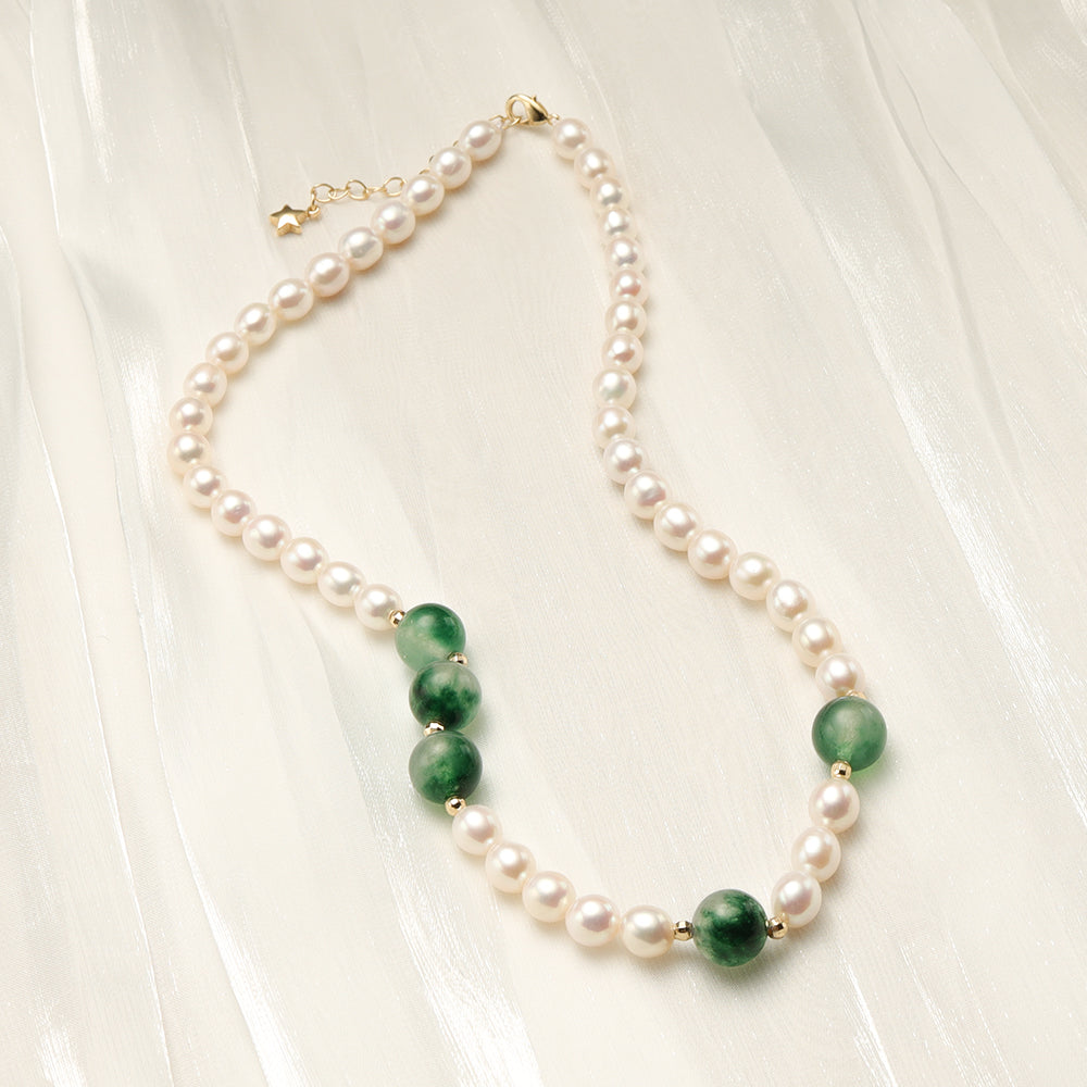 A jade pearl necklace on a soft and shining cloth.