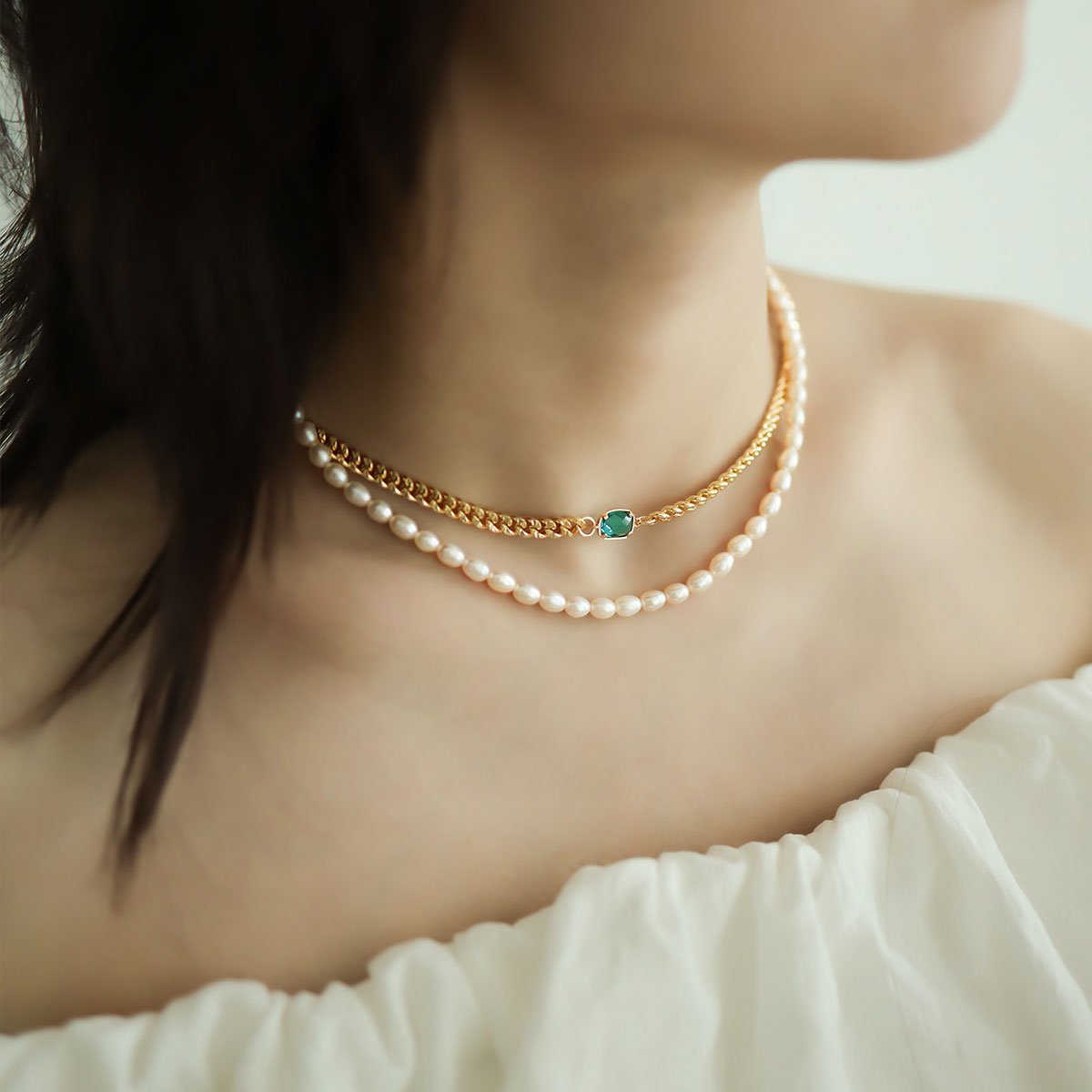 Women wear a layered beaded necklace.