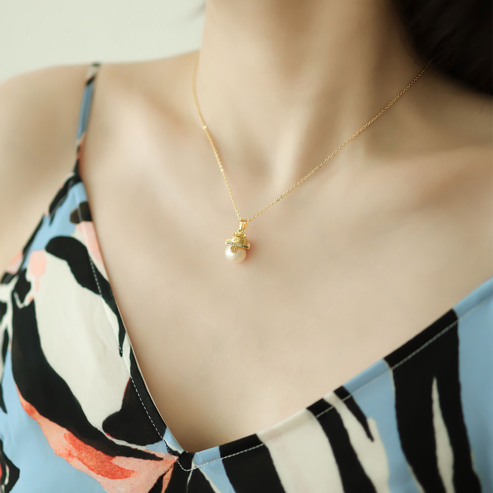 Women wear a lucky cat pendant.