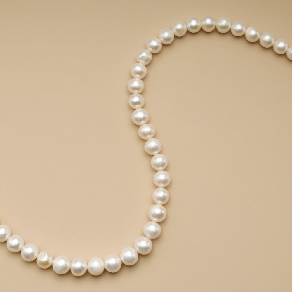 A string of pastel beads for jewelry making.