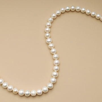 A string of pastel beads for jewelry making.