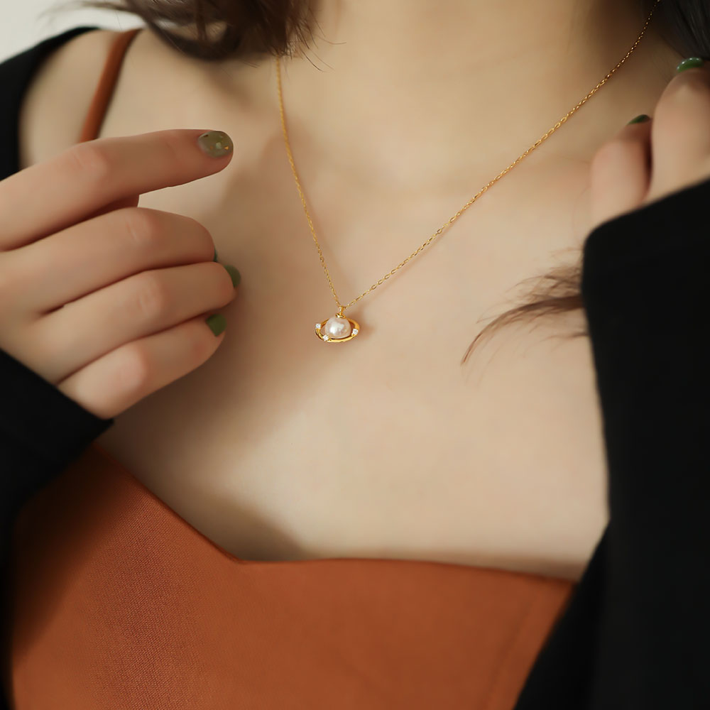 Women wear pearl and saturn necklace.