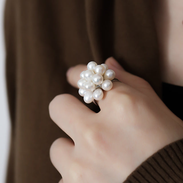 Pearl birthstone ring on women finger.