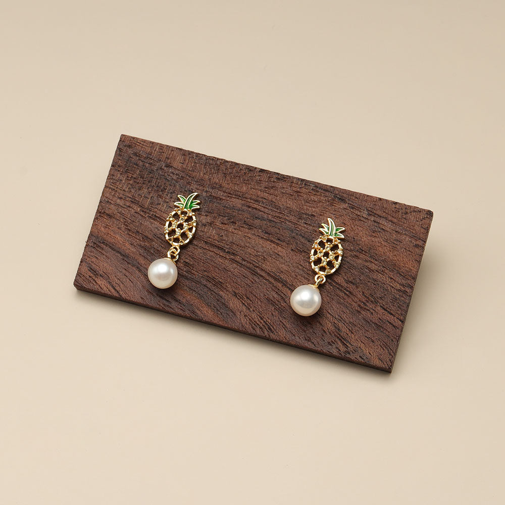A pair of pineapple pearl earrings.