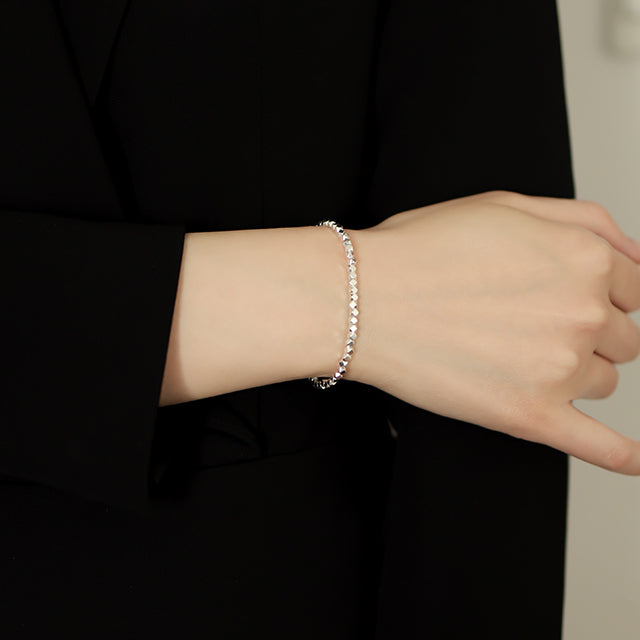 Women in black wear popular beaded bracelets.