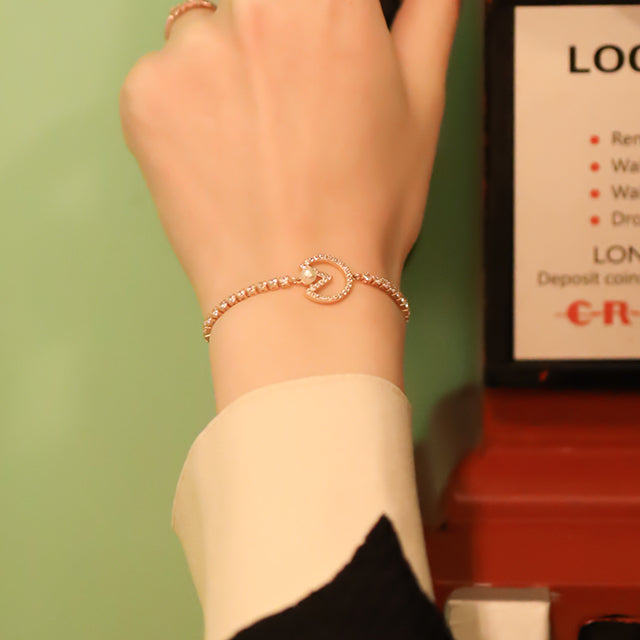 A rose gold diamond bracelet on women wrist.