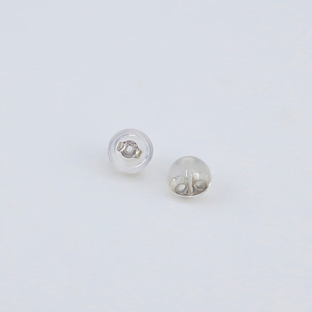 A pair of silver and rubber earrings backs.