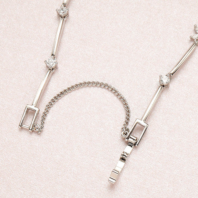 A open silver chain bracelet clasp.