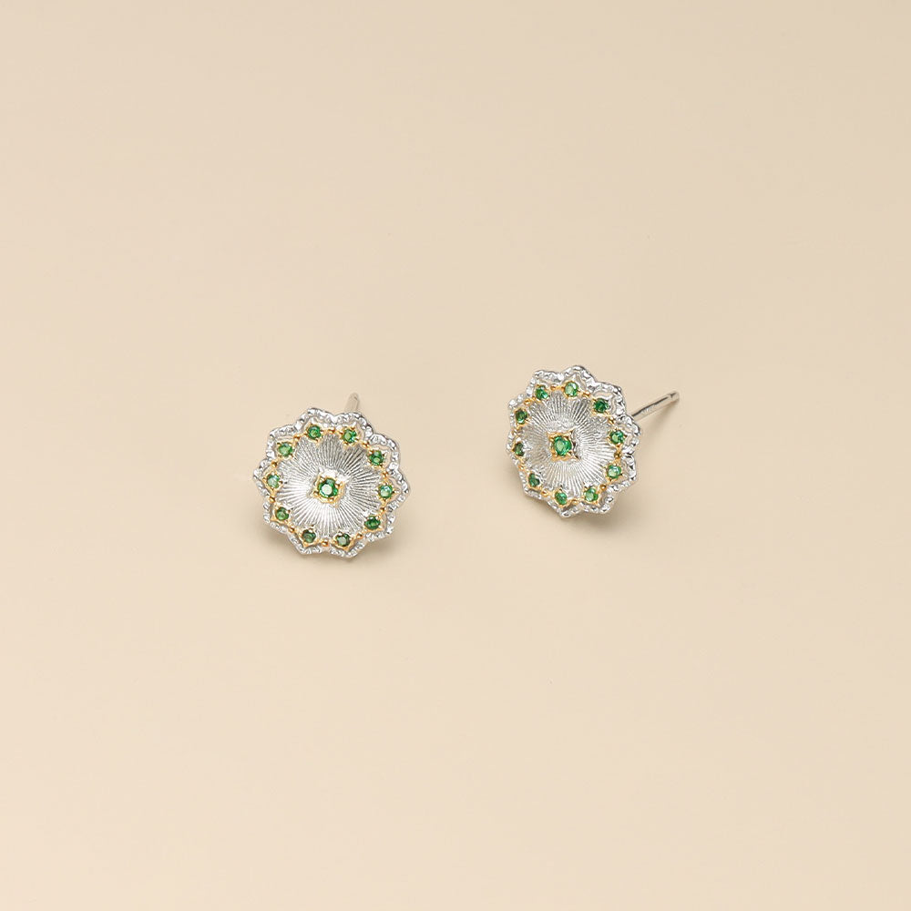 A pair of silver color earrings.