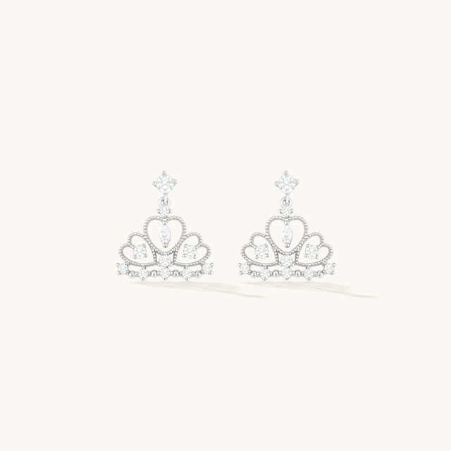 A pair of silver crown dangle earrings.