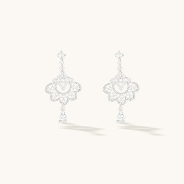 A pair of silver dangle earrings.