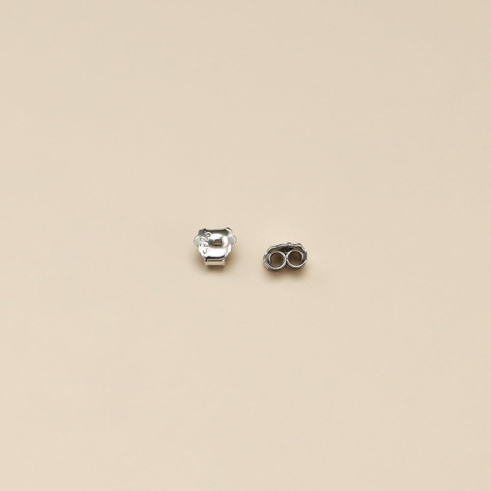 A pair of silver earrings backs.