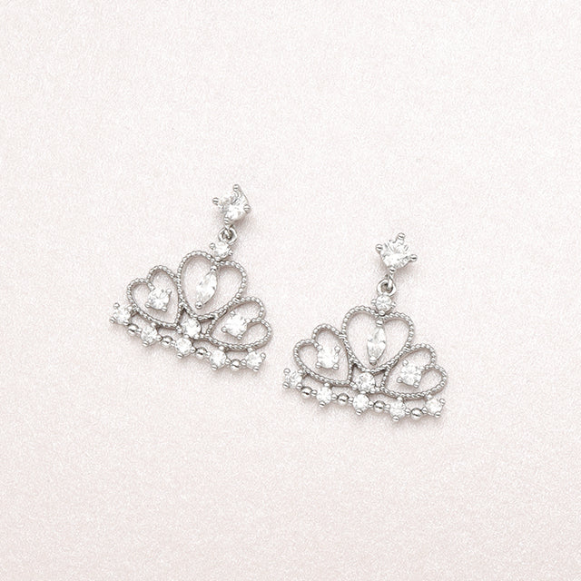 A pair of silver elegant earrings.