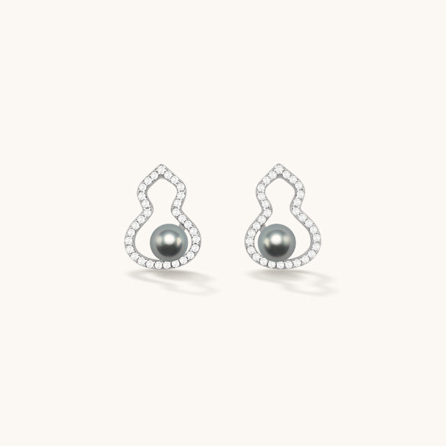 A pair of silver pearl stud earrings.
