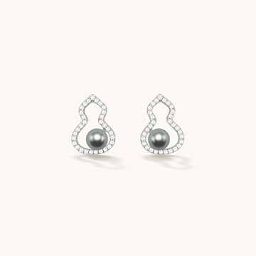 A pair of silver pearl stud earrings.