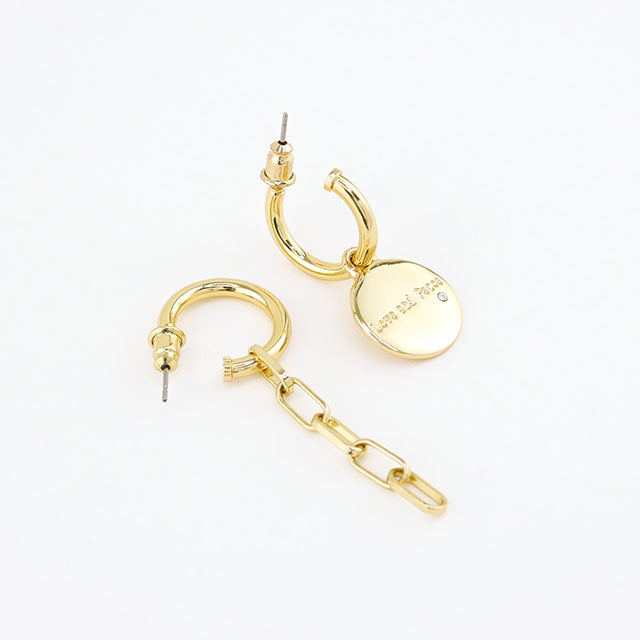 The side of small huggie hoop earrings.