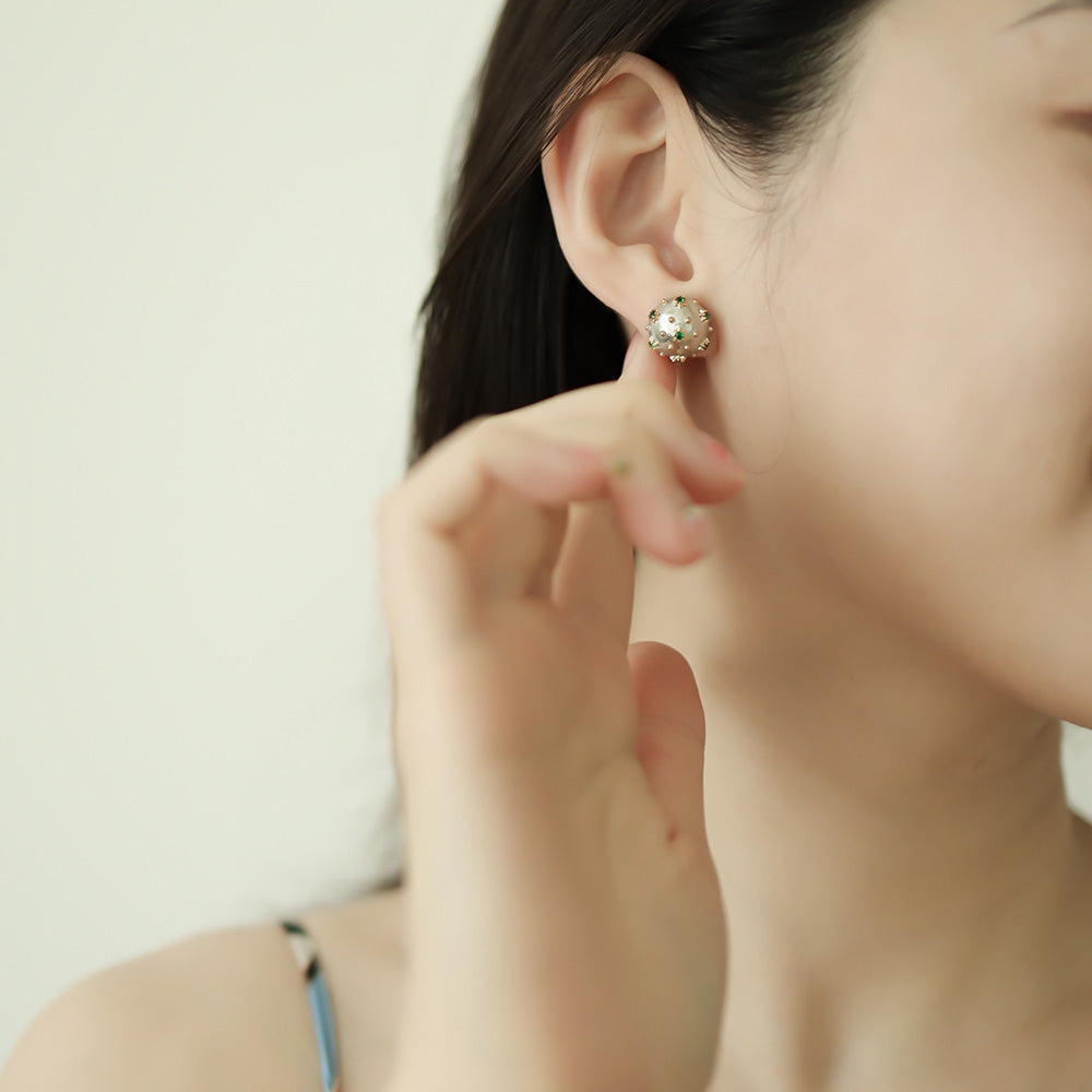 Women wear small silver stud earrings.