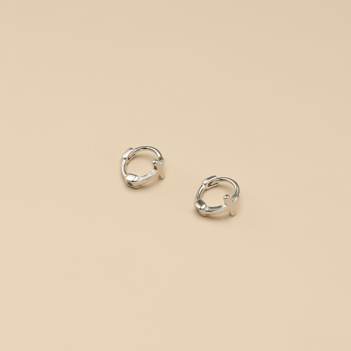 A pair of sterling silver helix earrings.