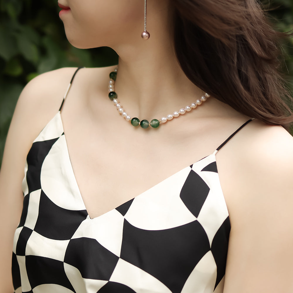 Women wear a summer pearl necklace and checkerboard slip dress.