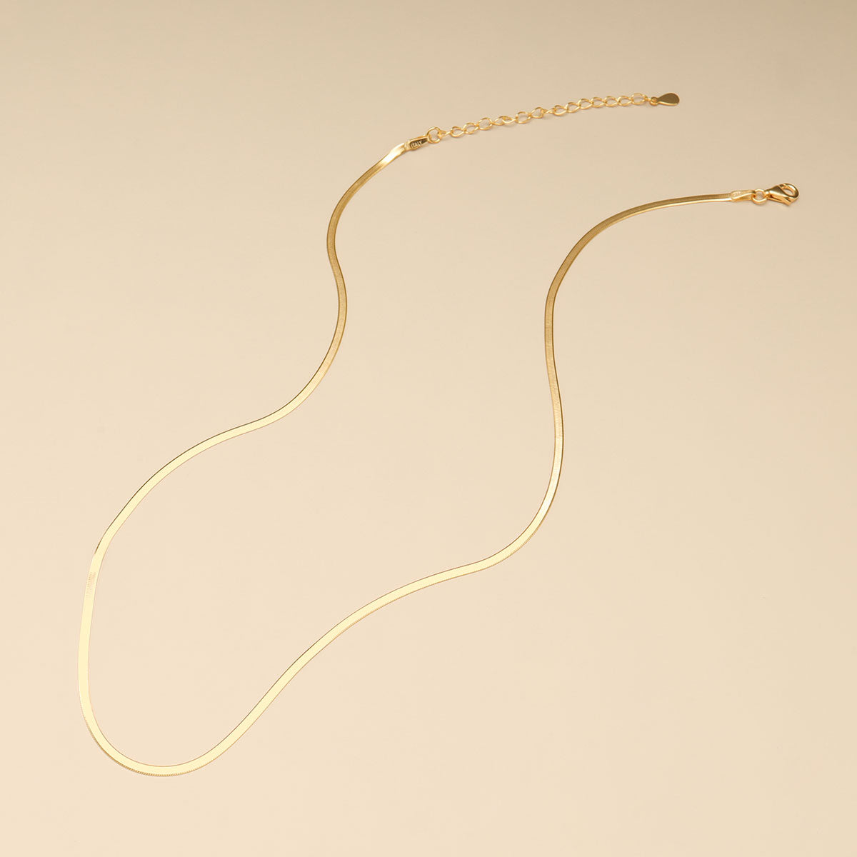 A thick gold chain on brown leather.