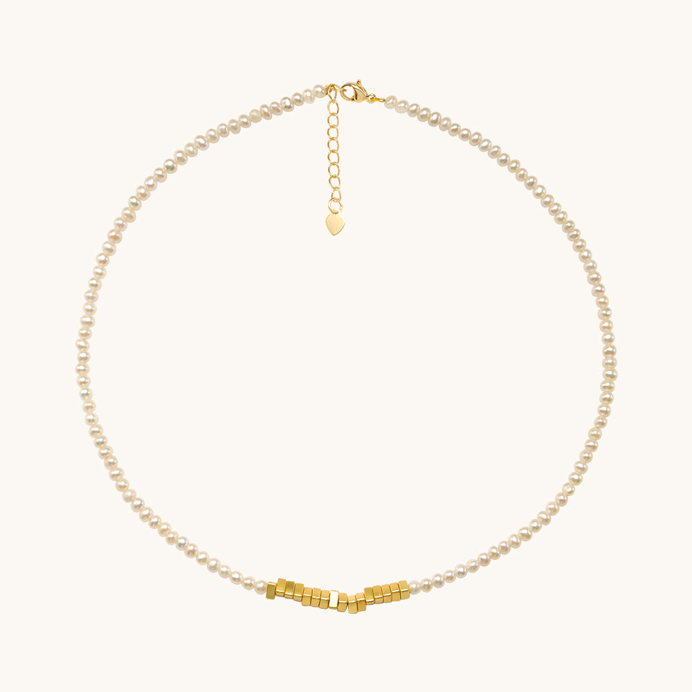 A tiny oearl necklace with adjustable lobster claw clasp.
