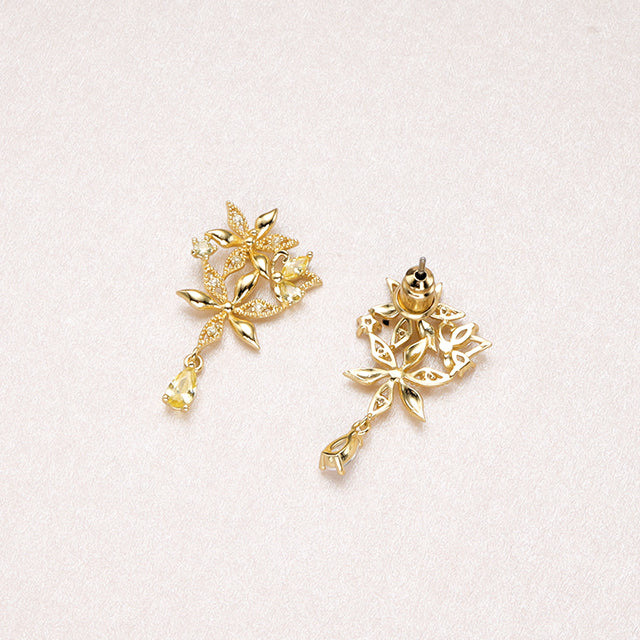 The back of vintage gold earrings with yellow zircon.